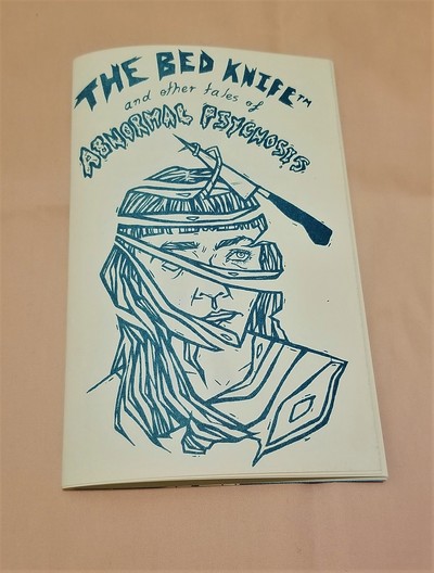 The image is a self portraits of a young, plain woman sliced into sections by a knife. The words “the bed knife and other tales of abnormal psychosis” are is hand lettered text, some sharp, some squiggly, all in teal risograph.